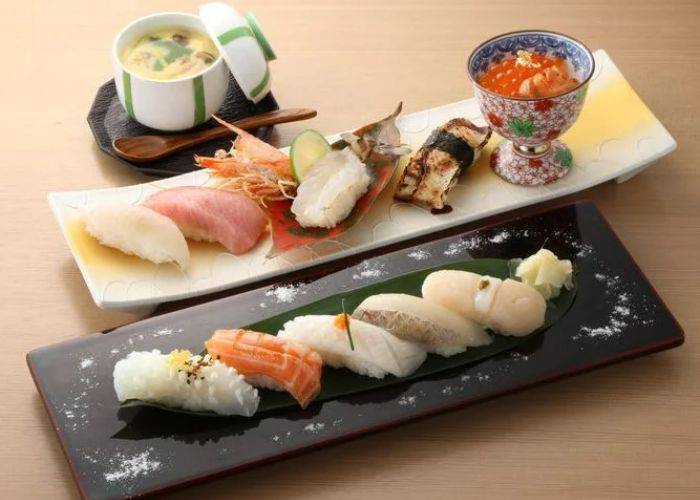 A selection of sushi platters at Sushi Tomo, including a serving a chawamushi and cod roe.